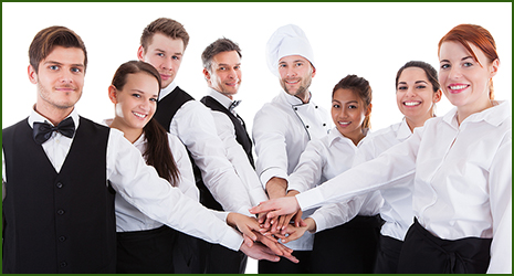 Waiters and waitresses stacking hands. Isolated on white